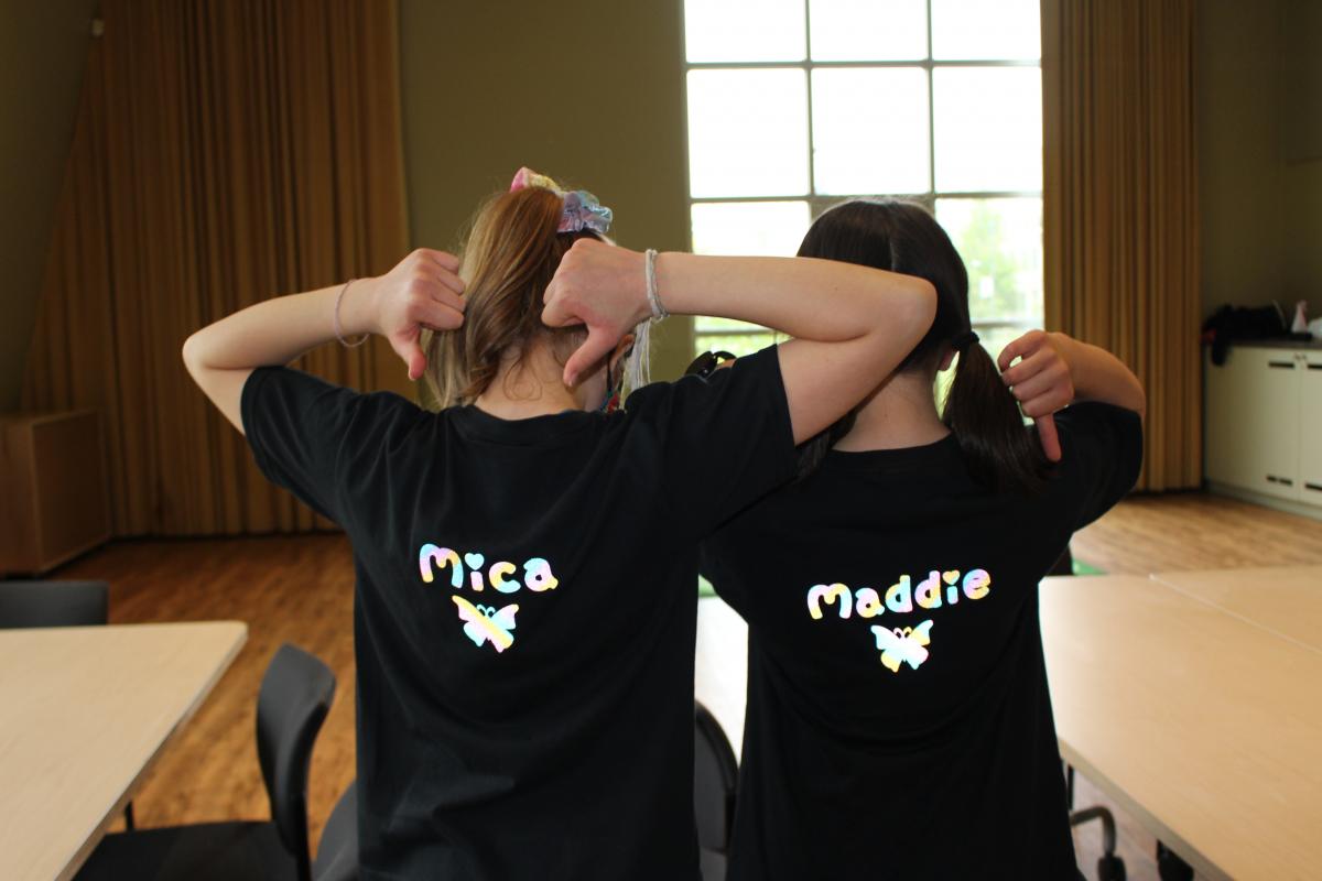 Mica and Maddie showing off their rainbow “M and M Studios” t-shirts